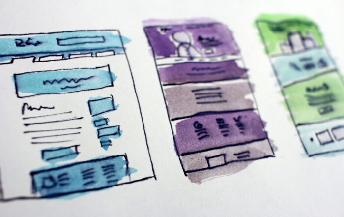 Hand-drawn watercolor sketches of website page layouts