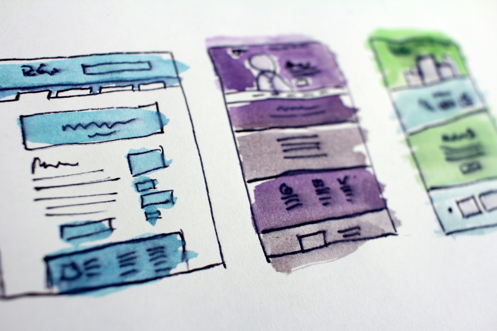 Hand-drawn watercolor sketches of website page layouts