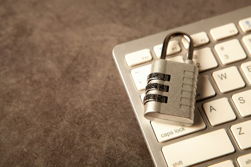 Combination padlock resting on a white computer keyboard, representing website and server security